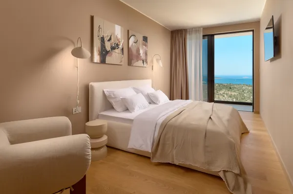 Modern bedroom with art and armchair